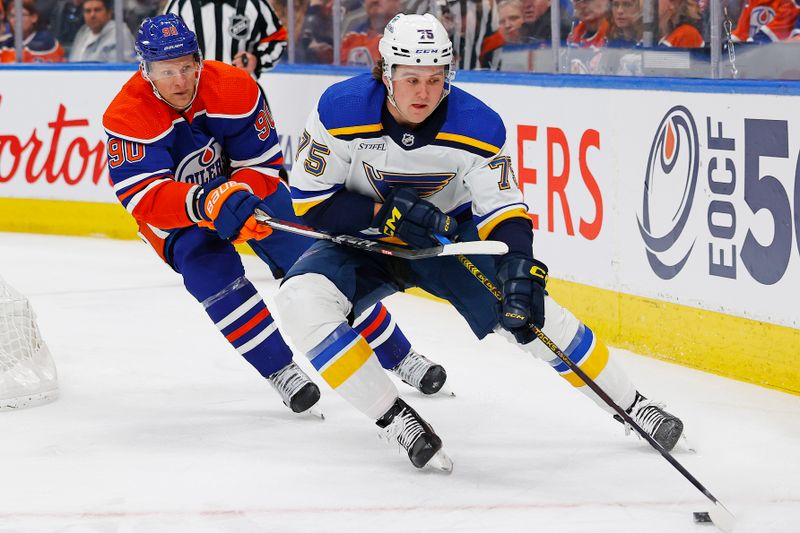 Feb 28, 2024; Edmonton, Alberta, CAN;  St. Louis Blues defensemen Tyler Tucker (75) tries to make a pass in front of Edmonton Oilers forward Corey Perry (90) during the first periodat Rogers Place. Mandatory Credit: Perry Nelson-USA TODAY Sports