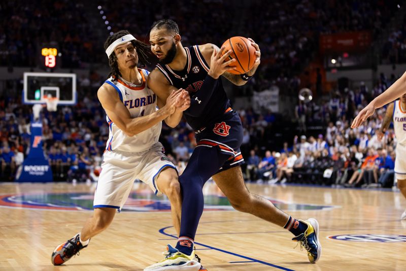 Feb 10, 2024; Gainesville, Florida, USA; Auburn Tigers forward Johni Broome (4) dribbles the ball against Florida Gators guard Walter Clayton Jr. (1) during the first half at Exactech Arena at the Stephen C. O'Connell Center. Mandatory Credit: Matt Pendleton-USA TODAY Sports