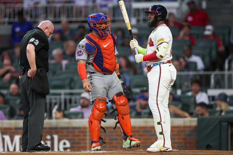 Sep 24, 2024; Atlanta, Georgia, USA; New York Mets catcher Francisco Alvarez (4) reacts after being hit by the bat of Atlanta Braves designated hitter Marcell Ozuna (20) in the first inning at Truist Park. Mandatory Credit: Brett Davis-Imagn Images