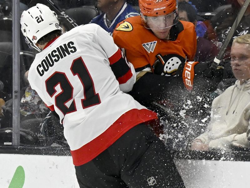 Dec 1, 2024; Anaheim, California, USA;  Ottawa Senators center Nick Cousins (21) checks Anaheim Ducks defenseman Pavel Mintyukov (34) into the boards during the third period at Honda Center. Mandatory Credit: Alex Gallardo-Imagn Images