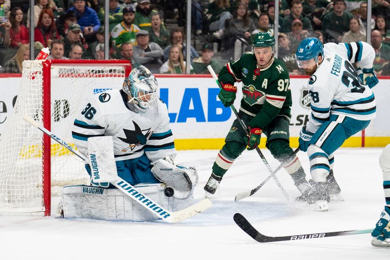 Mar 3, 2024; Saint Paul, Minnesota, USA; San Jose Sharks goaltender Kaapo Kahkonen (36) makes a save as Minnesota Wild left wing Kirill Kaprizov (97) awaits a rebound in the second period at Xcel Energy Center. Mandatory Credit: Matt Blewett-USA TODAY Sports