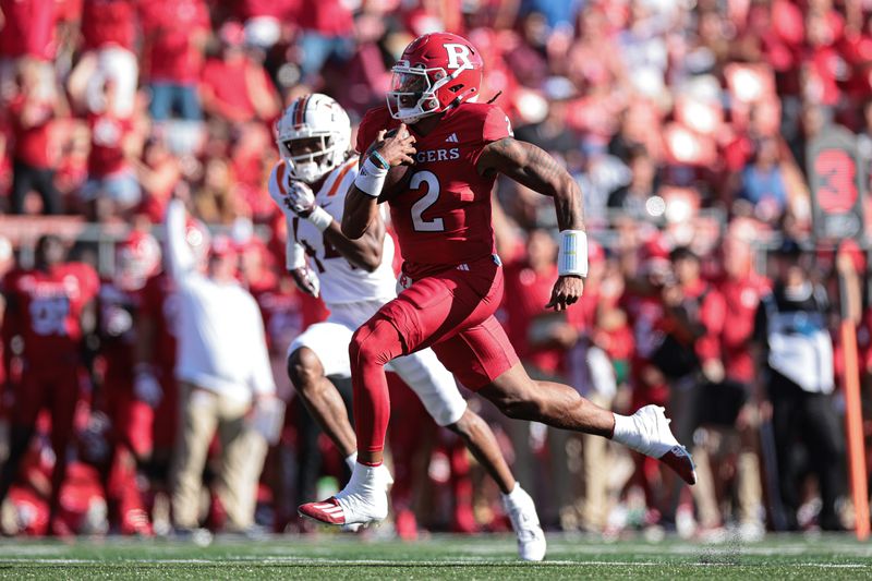 Sep 16, 2023; Piscataway, New Jersey, USA;  Rutgers Scarlet Knights quarterback Gavin Wimsatt (2) scores a rushing touchdown during the first half in front of Virginia Tech Hokies cornerback Dorian Strong (44) at SHI Stadium. Mandatory Credit: Vincent Carchietta-USA TODAY Sports