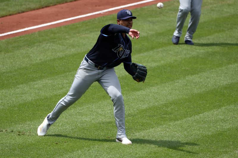 Jun 29, 2025; Baltimore, Maryland, USA; Tampa Bay Rays pitcher Taj Bradley (45) throws to first during the fifth inning against the Baltimore Orioles at Oriole Park at Camden Yards. Mandatory Credit: Daniel Kucin Jr.-Imagn Images