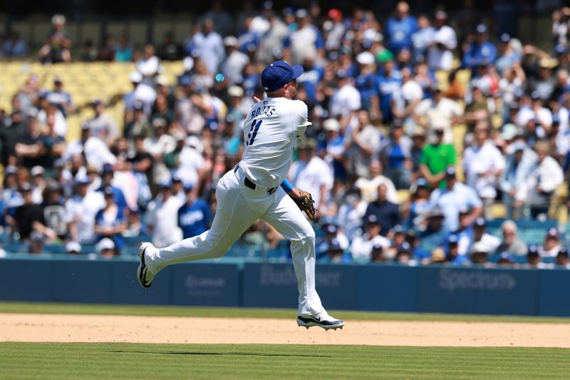 May 8, 2024; Los Angeles, California, USA;  Los Angeles Dodgers second baseman Miguel Rojas (11) throws the ball to first base for last out of the game in the ninth inning against the Miami Marlins at Dodger Stadium. Mandatory Credit: Kiyoshi Mio-USA TODAY Sports