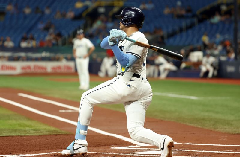 Sep 3, 2024; St. Petersburg, Florida, USA; Tampa Bay Rays infielder Christopher Morel (24) singles against the Minnesota Twins during the first inning at Tropicana Field. Mandatory Credit: Kim Klement Neitzel-Imagn Images