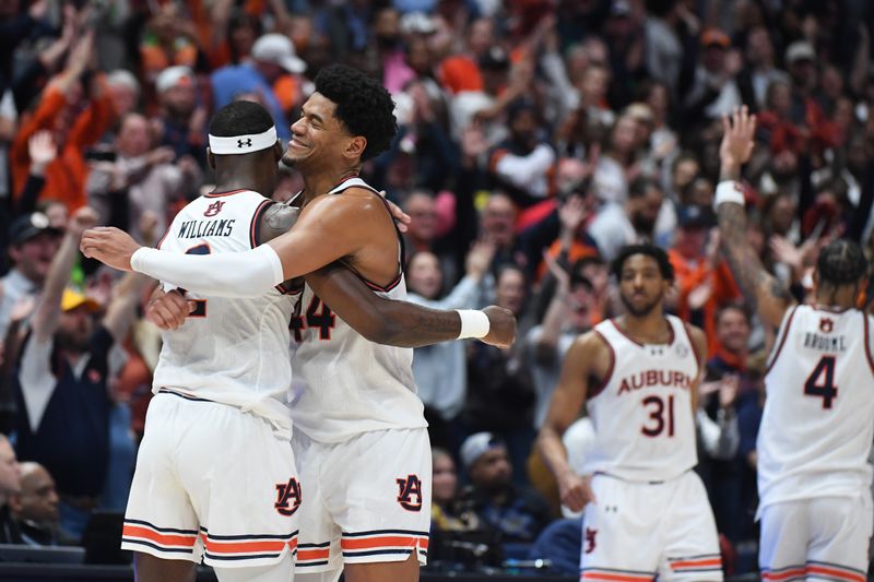 Mar 17, 2024; Nashville, TN, USA; Auburn Tigers center Dylan Cardwell (44) and forward Jaylin Williams (2) celebrate in the second half against the Florida Gators in the SEC Tournament championship game  at Bridgestone Arena. Mandatory Credit: Christopher Hanewinckel-USA TODAY Sports