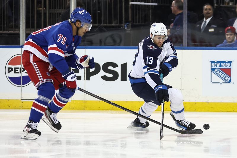 Nov 12, 2024; New York, New York, USA;  New York Rangers defenseman K'Andre Miller (79) and Winnipeg Jets center Gabriel Vilardi (13) battle for control of the puck in the first period at Madison Square Garden. Mandatory Credit: Wendell Cruz-Imagn Images