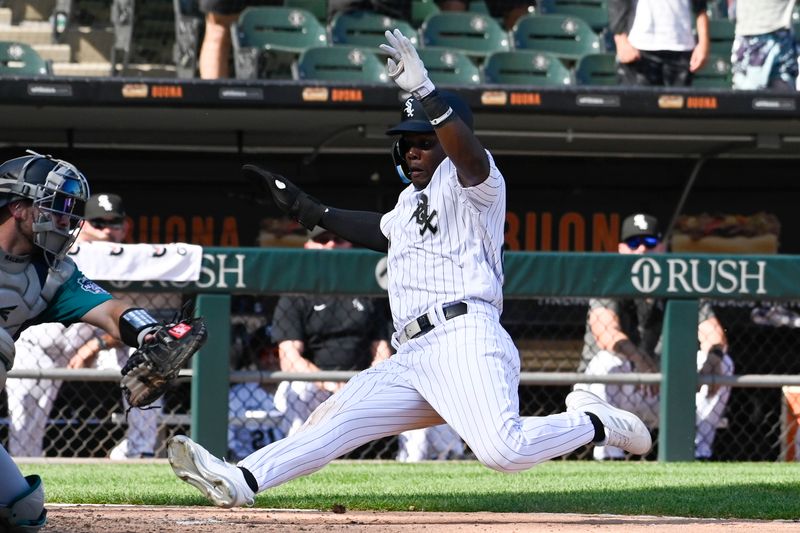 Aug 23, 2023; Chicago, Illinois, USA;  Chicago White Sox right fielder Oscar Colas (22) scores against the Seattle Mariners during the ninth inning at Guaranteed Rate Field. Mandatory Credit: Matt Marton-USA TODAY Sports