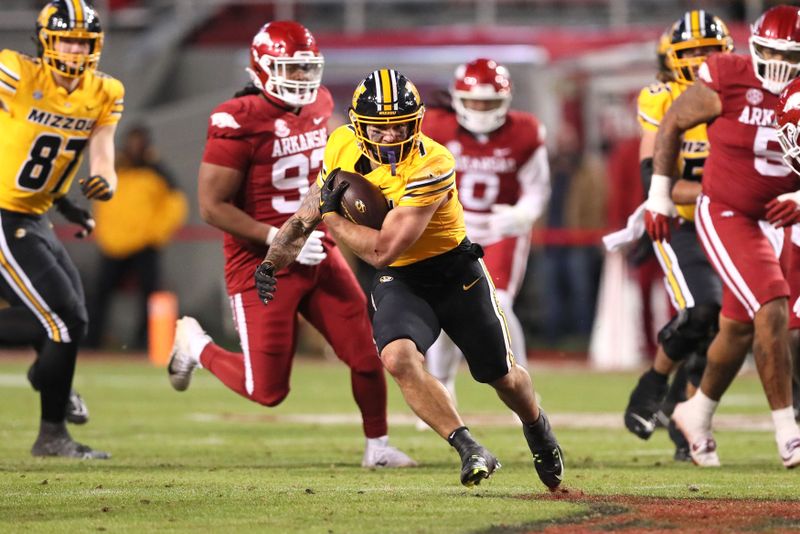 Nov 24, 2023; Fayetteville, Arkansas, USA; Missouri Tigers running back Cody Schrader (7) rushes during the second half against the Arkansas Razorbacks at Donald W. Reynolds Razorback Stadium. Missouri won 48-14. Mandatory Credit: Nelson Chenault-USA TODAY Sports