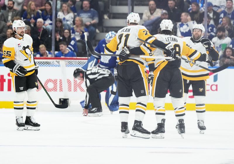 Oct 12, 2024; Toronto, Ontario, CAN; Pittsburgh Penguins defenseman Kris Letang (58) scores a goal and celebrates with center Evgeni Malkin (71) against the Toronto Maple Leafs during the first period at Scotiabank Arena. Mandatory Credit: Nick Turchiaro-Imagn Images