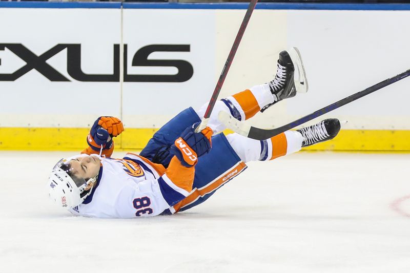 Sep 26, 2023; New York, New York, USA;  New York Islanders forward Arnaud Durandeau (38) falls to the ice after a collision in the second period against the New York Rangers at Madison Square Garden. Mandatory Credit: Wendell Cruz-USA TODAY Sports