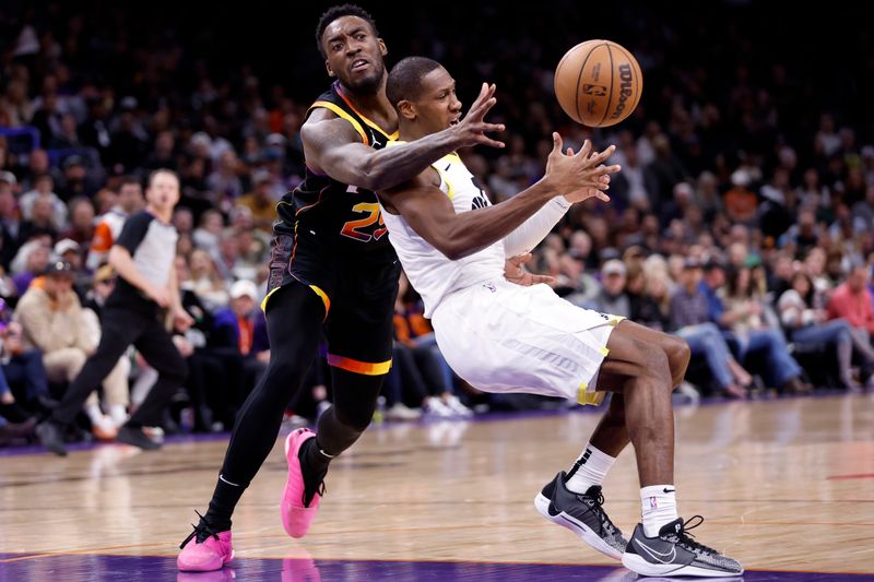 PHOENIX, ARIZONA - FEBRUARY 08: Kris Dunn (R) #11 of the Utah Jazz and Nassir Little #25 of the Phoenix Suns battle for a loose ball during the first half at Footprint Center on February 08, 2024 in Phoenix, Arizona. NOTE TO USER: User expressly acknowledges and agrees that, by downloading and or using this photograph, User is consenting to the terms and conditions of the Getty Images License Agreement.  (Photo by Chris Coduto/Getty Images)