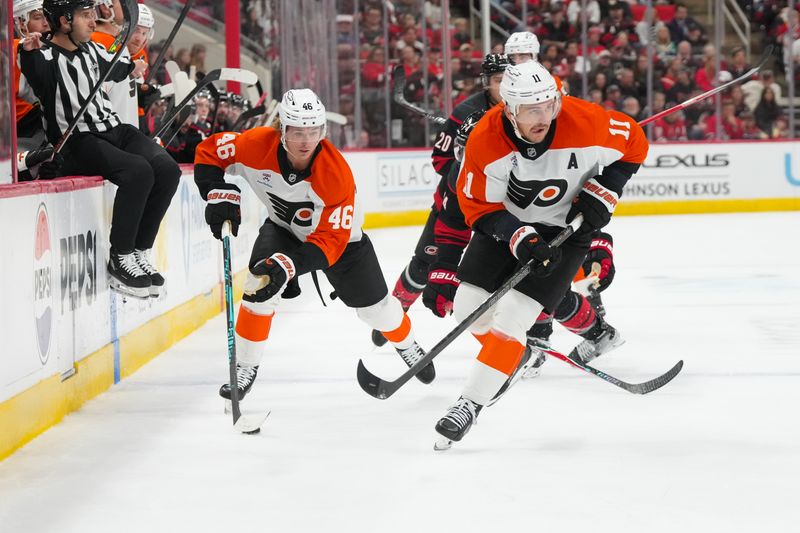 Oct 11, 2025; Raleigh, North Carolina, USA;  Philadelphia Flyers center Trevor Zegras (46) skates with the puck next to right wing Travis Konecny (11) against the Carolina Hurricanes during the second period at Lenovo Center. Mandatory Credit: James Guillory-Imagn Images