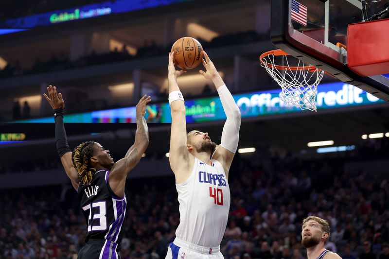 SACRAMENTO, CALIFORNIA - APRIL 02: Ivica Zubac #40 of the LA Clippers goes up for a shot on Keon Ellis #23 of the Sacramento Kings in the first half at Golden 1 Center on April 02, 2024 in Sacramento, California. NOTE TO USER: User expressly acknowledges and agrees that, by downloading and or using this photograph, User is consenting to the terms and conditions of the Getty Images License Agreement.  (Photo by Ezra Shaw/Getty Images)