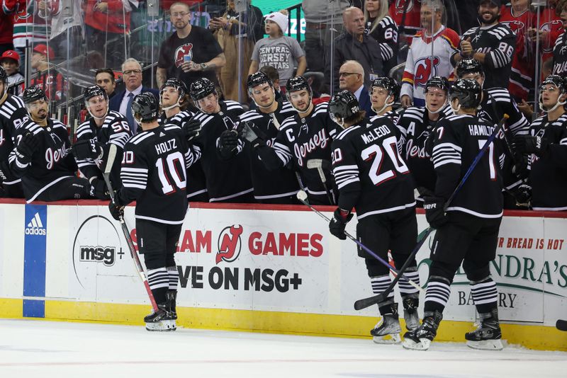 Oct 27, 2023; Newark, New Jersey, USA; New Jersey Devils right wing Alexander Holtz (10) celebrates his goal with teammates during the first period against the Buffalo Sabres at Prudential Center. Mandatory Credit: Vincent Carchietta-USA TODAY Sports