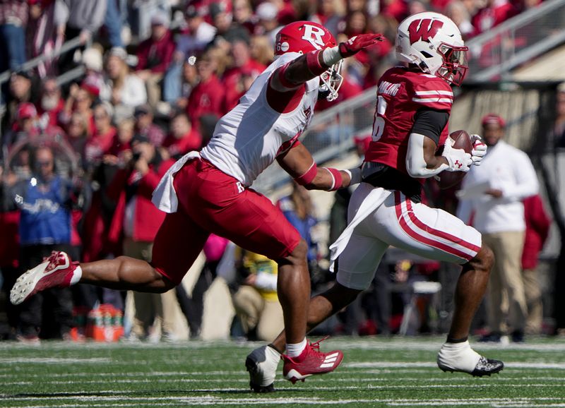 Oct 7, 2023; Madison, Wisconsin, USA; Wisconsin wide receiver Will Pauling (6) is pursued by Rutgers defensive back Shaquan Loyal (6) after a reception during the second quarter at Camp Randall Stadium. Mandatory Credit: Mark Hoffman-USA TODAY Sports