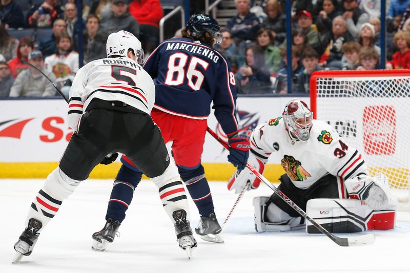 Nov 22, 2023; Columbus, Ohio, USA; Chicago Blackhawks goalie Petr Mrazek (34) stops the shots from Columbus Blue Jackets right wing Kirill Marchenko (86) during the first period at Nationwide Arena. Mandatory Credit: Russell LaBounty-USA TODAY Sports