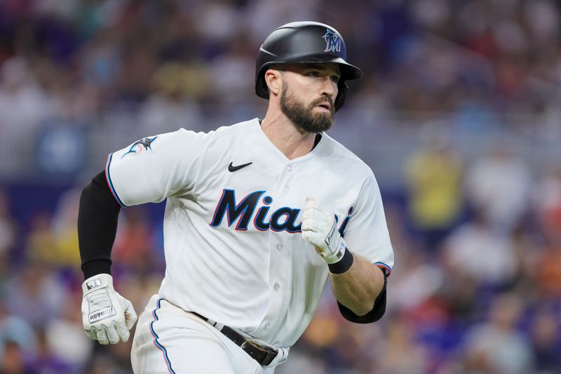 Jul 30, 2023; Miami, Florida, USA; Miami Marlins shortstop Jon Berti (5) hits a single against the Detroit Tigers during the seventh inning at loanDepot Park. Mandatory Credit: Sam Navarro-USA TODAY Sports