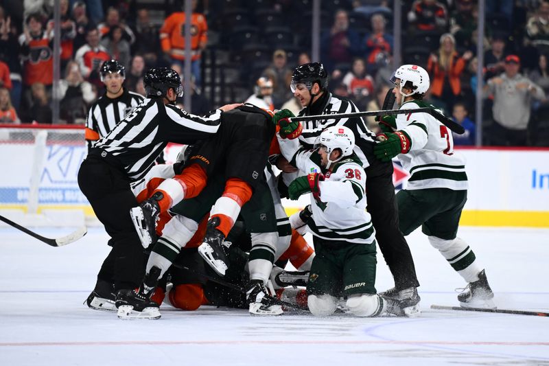 Oct 26, 2024; Philadelphia, Pennsylvania, USA; Philadelphia Flyers right wing Garnet Hathaway (19) jumps on a pile during a scuffle against the Minnesota Wild in the third period at Wells Fargo Center. Mandatory Credit: Kyle Ross-Imagn Images