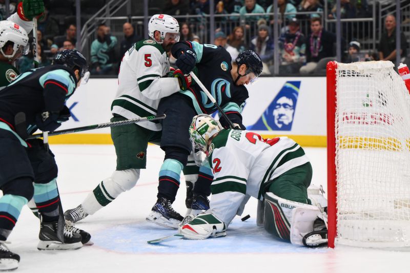 Dec 10, 2023; Seattle, Washington, USA; Minnesota Wild goaltender Filip Gustavsson (32) blocks a goal shot by Seattle Kraken right wing Eeli Tolvanen (20) during the second period at Climate Pledge Arena. Mandatory Credit: Steven Bisig-USA TODAY Sports