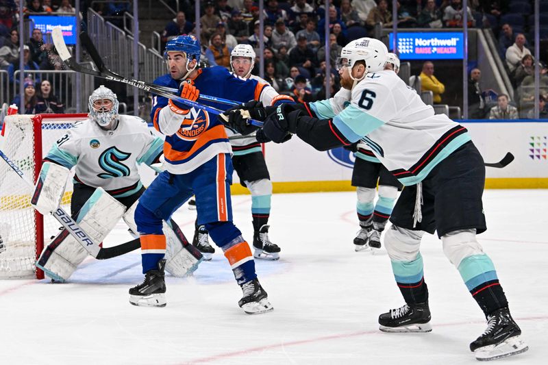 Feb 13, 2024; Elmont, New York, USA; New York Islanders center Kyle Palmieri (21) and Seattle Kraken defenseman Adam Larsson (6) battle for the puck during the second period at UBS Arena. Mandatory Credit: Dennis Schneidler-USA TODAY Sports