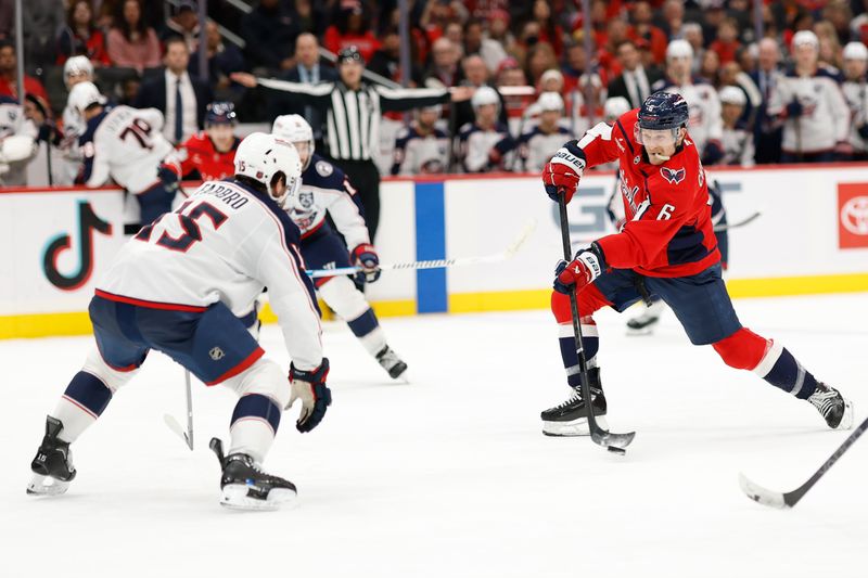 Nov 24, 2025; Washington, District of Columbia, USA; Washington Capitals defenseman Jakob Chychrun (6) shoots the puck as Columbus Blue Jackets defenseman Dante Fabbro (15) defends during the third period at Capital One Arena. Mandatory Credit: Geoff Burke-Imagn Images