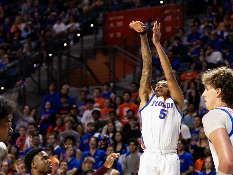 Jan 24, 2024; Gainesville, Florida, USA; Florida Gators guard Will Richard (5) shoots over Mississippi State Bulldogs guard Josh Hubbard (13) during the second half at Exactech Arena at the Stephen C. O'Connell Center. Mandatory Credit: Matt Pendleton-USA TODAY Sports