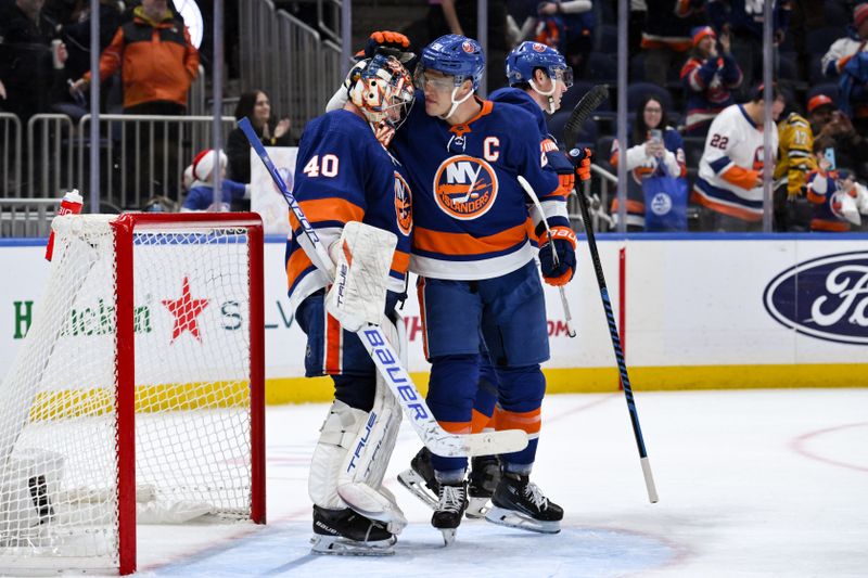 Dec 7, 2023; Elmont, New York, USA; New York Islanders goaltender Semyon Varlamov (40) is greeted by New York Islanders left wing Anders Lee (27) after defeating the Columbus Blue Jackets at UBS Arena. Mandatory Credit: John Jones-USA TODAY Sports