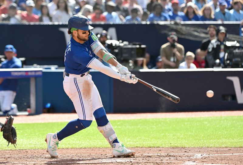 Jul 29, 2023; Toronto, Ontario, CAN;  Toronto Blue Jays shortstop Bo Bichette (11) hits a double against the Los Angeles Angels in the fifth inning at Rogers Centre. Mandatory Credit: Dan Hamilton-USA TODAY Sports