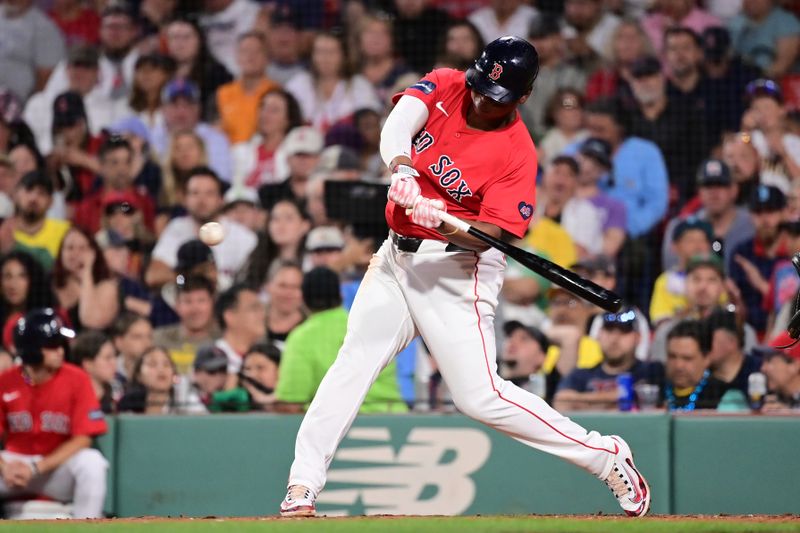 Jun 28, 2024; Boston, Massachusetts, USA; Boston Red Sox third baseman Rafael Devers (11) hits a home run against the San Diego Padres during the sixth inning at Fenway Park. Mandatory Credit: Eric Canha-USA TODAY Sports