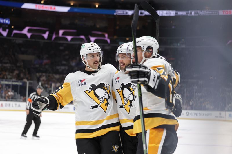 Nov 9, 2023; Los Angeles, California, USA; Pittsburgh Penguins defensemen Erik Karlsson (65), defensemen Kris Letang (58) and center Sidney Crosby (87) celebrate after a goal by center Sidney Crosby (87) in the first period against the Los Angeles Kings at Crypto.com Arena. Mandatory Credit: Yannick Peterhans-USA TODAY Sports