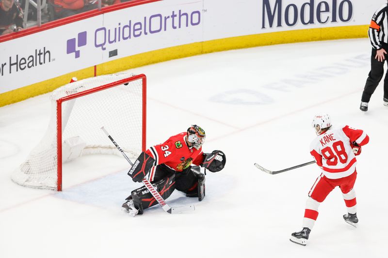 Feb 25, 2024; Chicago, Illinois, USA; Detroit Red Wings right wing Patrick Kane (88) scores game winning goal against Chicago Blackhawks goaltender Petr Mrazek (34) in overtime at United Center. Mandatory Credit: Kamil Krzaczynski-USA TODAY Sports