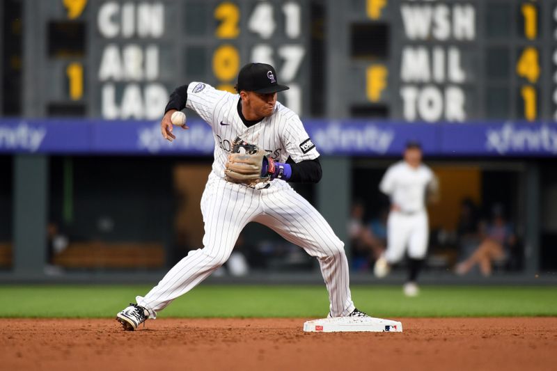 Aug 30, 2025; Denver, Colorado, USA; Colorado Rockies second baseman Ryan Ritter (8) loses control of the ball on a double play attempt during the third inning against the Chicago Cubs at Coors Field. Mandatory Credit: Christopher Hanewinckel-Imagn Images