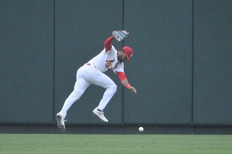 Apr 10, 2024; St. Louis, Missouri, USA; St. Louis Cardinals center fielder Victor Scott II (11) makes an error on a fly ball by Philadelphia Phillies catcher J.T. Realmuto (not pictured) during the first inning at Busch Stadium. Mandatory Credit: Jeff Curry-USA TODAY Sports