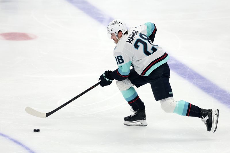 Dec 22, 2025; Anaheim, California, USA;  Seattle Kraken defenseman Joshua Mahura (28) skates with the puck during the third period against the Anaheim Ducks at Honda Center. Mandatory Credit: Kiyoshi Mio-Imagn Images