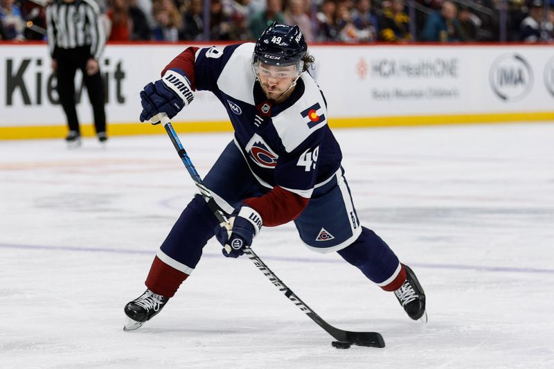 Jan 18, 2025; Denver, Colorado, USA; Colorado Avalanche defenseman Samuel Girard (49) takes a shot in the second period against the Dallas Stars at Ball Arena. Mandatory Credit: Isaiah J. Downing-Imagn Images