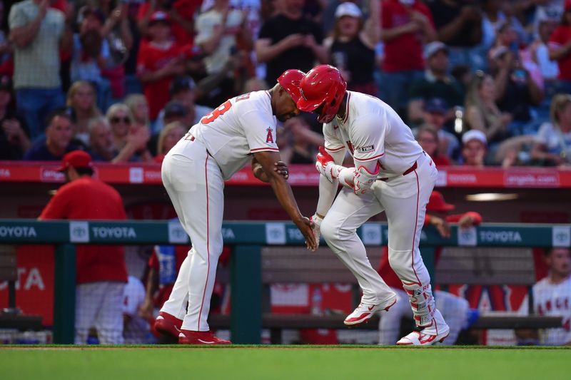 May 10, 2025; Anaheim, California, USA; Los Angeles Angels right fielder Jo Adell (7) is greeted by third base coach Bo Porter (88) after hitting a solo home run against the Baltimore Orioles during the fourth inning at Angel Stadium. Mandatory Credit: Gary A. Vasquez-Imagn Images