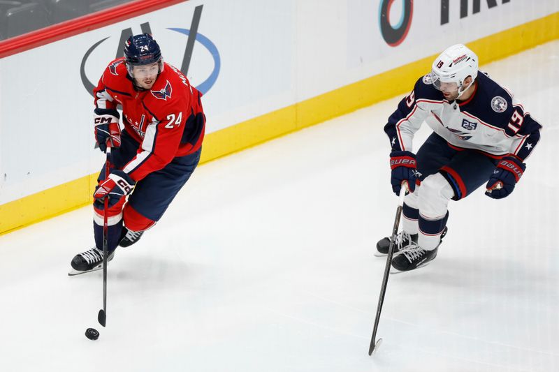 Oct 4, 2025; Washington, District of Columbia, USA; Washington Capitals center Connor McMichael (24) skates with the puck as Columbus Blue Jackets center Adam Fantilli (19) defends in the third period at Capital One Arena. Mandatory Credit: Geoff Burke-Imagn Images