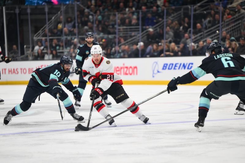 Mar 7, 2026; Seattle, Washington, USA; Ottawa Senators center Nick Cousins (21) advances the puck while defended by Seattle Kraken center Matty Beniers (10) during the third period at Climate Pledge Arena. Mandatory Credit: Steven Bisig-Imagn Images