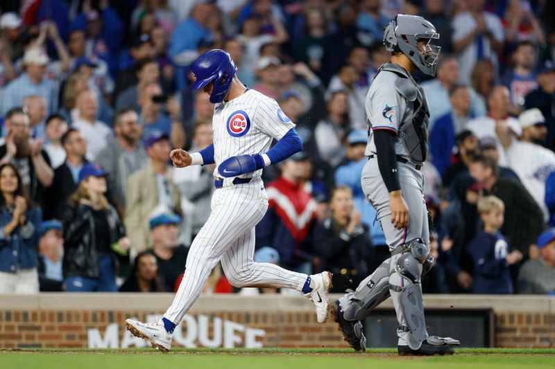 May 13, 2025; Chicago, Illinois, USA; Chicago Cubs second baseman Nico Hoerner (2) scores against the Miami Marlins during the fifth inning at Wrigley Field. Mandatory Credit: Kamil Krzaczynski-Imagn Images