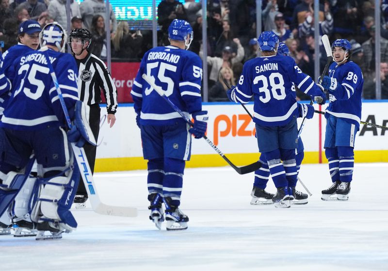 Oct 20, 2022; Toronto, Ontario, CAN; Toronto Maple Leafs left wing Nicholas Robertson (89) scores the winning goal and celebrates the win with Toronto Maple Leafs defenseman Rasmus Sandin (38) against the Dallas Stars during the overtime period at Scotiabank Arena. Mandatory Credit: Nick Turchiaro-USA TODAY Sports