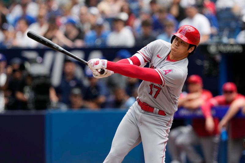 Jul 30, 2023; Toronto, Ontario, CAN; Los Angeles Angels designated hitter Shohei Ohtani (17) swings at a pitch against the Toronto Blue Jays during the third inning at Rogers Centre. Mandatory Credit: John E. Sokolowski-USA TODAY Sports