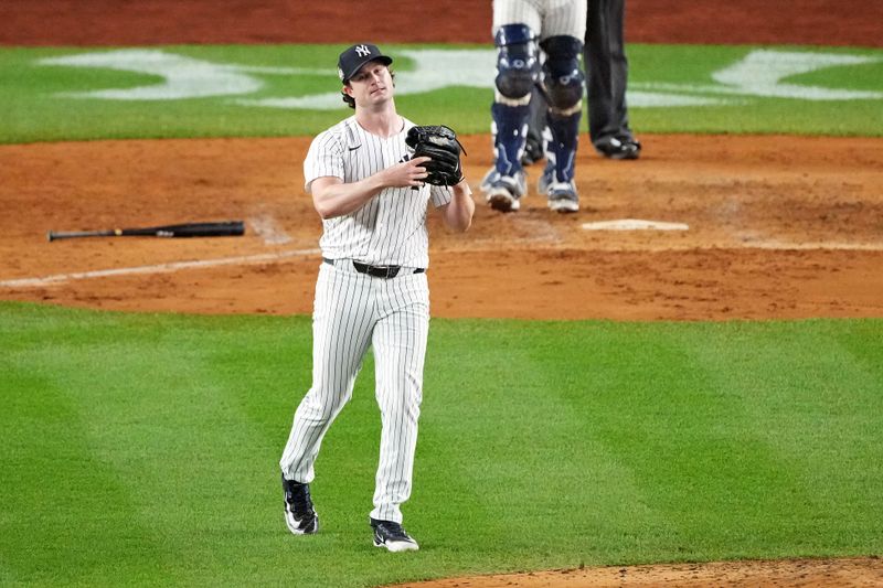 Oct 30, 2024; New York, New York, USA; New York Yankees pitcher Gerrit Cole (45) reacts after giving up a hit during the fifth inning against the Los Angeles Dodgers in game four of the 2024 MLB World Series at Yankee Stadium. Mandatory Credit: Robert Deutsch-Imagn Images