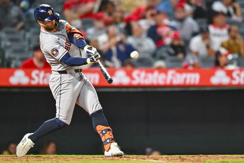 Sep 27, 2025; Anaheim, California, USA; Houston Astros first baseman Christian Walker (8) hits a solo home run against the Los Angeles Angels during the ninth inning at Angel Stadium. Mandatory Credit: Jonathan Hui-Imagn Images