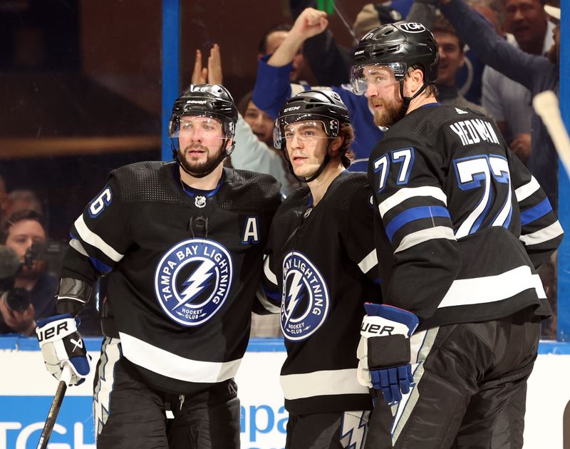 Feb 15, 2024; Tampa, Florida, USA; Tampa Bay Lightning center Brayden Point (21) is congratulated by defenseman Victor Hedman (77) and right wing Nikita Kucherov (86) after he scored a final against the Colorado Avalanche uring the first period at Amalie Arena. Mandatory Credit: Kim Klement Neitzel-USA TODAY Sports