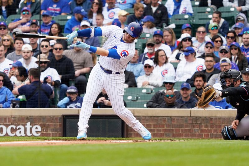 May 6, 2023; Chicago, Illinois, USA; Chicago Cubs left fielder Ian Happ (8) hits a single against the Miami Marlins during the first inning at Wrigley Field. Mandatory Credit: David Banks-USA TODAY Sports