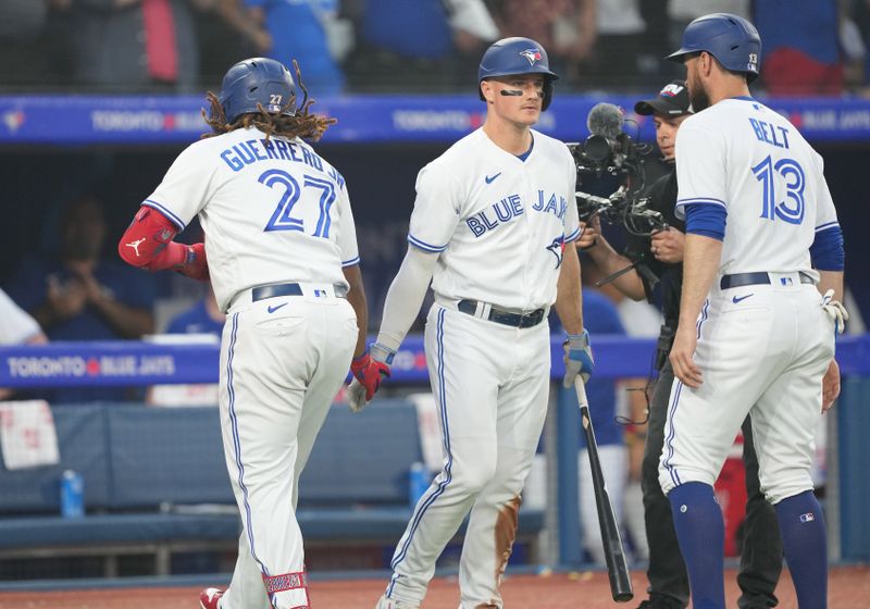 Jun 29, 2023; Toronto, Ontario, CAN; Toronto Blue Jays designated hitter Vladimir Guerrero Jr. (27) hits a two run home run and celebrates with Toronto Blue Jays third baseman Matt Chapman (26) against the San Francisco Giants during the sixth inning at Rogers Centre. Mandatory Credit: Nick Turchiaro-USA TODAY Sports