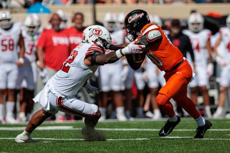 Sep 21, 2024; Stillwater, Oklahoma, USA; Oklahoma State Cowboys wide receiver Brennan Presley (80) collides with Utah Utes linebacker Sione Fotu (12) during the first quarter at Boone Pickens Stadium. Mandatory Credit: William Purnell-Imagn Images