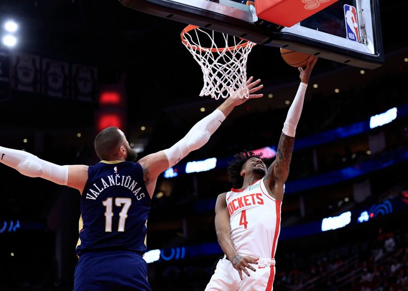 HOUSTON, TEXAS - JANUARY 31: Jalen Green #4 of the Houston Rockets drives to the net ahead of Jonas Valanciunas #17 of the New Orleans Pelicans during the first half at Toyota Center on January 31, 2024 in Houston, Texas. NOTE TO USER: User expressly acknowledges and agrees that, by downloading and or using this photograph, User is consenting to the terms and conditions of the Getty Images License Agreement.? (Photo by Carmen Mandato/Getty Images)