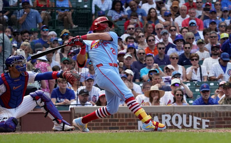Aug 3, 2024; Chicago, Illinois, USA; St. Louis Cardinals outfielder Lars Nootbaar (21) hits a one-run sacrifice against the Chicago Cubs during the ninth inning at Wrigley Field. Mandatory Credit: David Banks-USA TODAY Sports